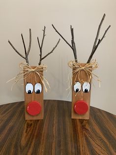 two wooden reindeer head vases sitting on top of a table