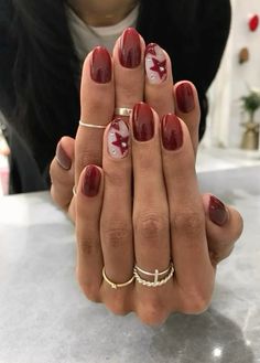 Maroon Nails With Stars, Cool Girl Christmas Nails, Red Biab Nail Designs, Autumn Nails Dark Red, Red Eras Tour Nails, Dark Red Nail Art Designs, Coquette Fall Nails, Paris Nails Aesthetic, Short Almond Nails Designs Fall 2024