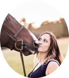 a woman is kissing a horse on the nose