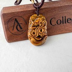 This is a Tiger Eye pendant necklace. The pendant is completely natural tiger eye, un-dyed and in its natural form. The pendant is carved in the form of the Chinese Zodiac - Snake. Size: ~1.40 x0.90 x 0.25 in. The years of the Snake include 1917, 1929, 1941, 1953, 1965, 1977, 1989, 2001, 2013, 2025, 2037... The necklace is adjustable - one size fits all. It comes with a gift box. The item is hand carved and natural so it may have imperfections because of the nature of stone or the carving. Brown Carved Amulet Necklaces, Brown Carved Pendant Necklace, Symbolic Carved Brown Jewelry, Brown Carved Spiritual Jewelry, Spiritual Brown Carved Jewelry, Spiritual Brown Carved Necklace, Carved Amber Necklace For Gift, Brown Carved Jewelry Gift, Carved Brown Jewelry For Gifts