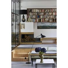 a living room filled with furniture and bookshelves