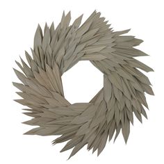 a wreath made out of white paper on a white background with no people around it