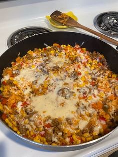 a pan filled with food sitting on top of a stove