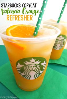 starbucks orange refresher drink with straws in cups on green paper napkins