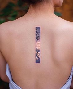 the back of a woman's neck with a tattoo on it