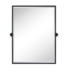 a black framed mirror sitting on top of a white wall