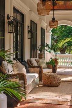 a porch with wicker furniture and potted plants