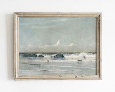 a painting hanging on the wall next to a white wall with an ocean scene in it