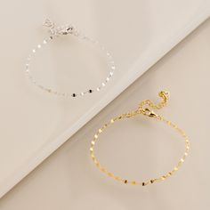 Our Josephine Chain Bracelet is a unique and dainty twist on a traditional anchor link. Each charm is placed perfectly to deliver a mirror-like glow. This the perfect versatile piece to wear alone or dress up your wrist stack. • Material: High Quality Solid 925 Sterling Silver• Finish: Sterling Silver ∙ 18K Gold• Featuring a dainty mirror link chain with adjustable length from 6 to 8 inches SKU: RR-BR024 Minimalist Chain Bracelets For Party, Dainty Metal Charm Bracelet For Party, Dainty Charm Bracelet With Delicate Chain, Dainty Link Charm Bracelet With Delicate Chain, Delicate Chain Bracelets For Parties, Silver Bracelets With Gold Chain For Wedding, Minimalist Bangle Chain Bracelet For Parties, Dainty Tarnish Resistant Bracelets For Party, Dainty Gold Plated Box Chain Bracelet