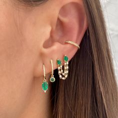 Pave Diamond & Emerald Drop Huggie Pierced Earrings 14K Yellow Gold 0.07 Pave Diamond Carat Weight 0.13 Emerald Carat Weight 0.65 Inches Long 0.43 Inch Diameter Ear Piercings Emerald, Green Earring Stacks, Emerald Ear Stack, Double Piercing Chain Earrings, Green And Gold Earring Stack, Emerald Earring Stack, Gold And Emerald Earrings, Gold And Emerald Jewelry, Emerald Piercing