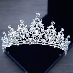 a tiara is shown on top of a black box with an iphone in the background