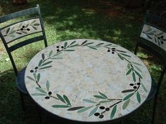 a table and two chairs sitting in the grass