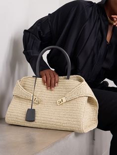 It's easy to see why Ferragamo's tote is named 'Hug' - the tabs (which can be undone for easier access through the top) wrap around the body just like one. Made from raffia, this medium-sized style has gold-tone 'Gancini' buckles and studs at the base to protect it from getting easily scratched and comes with two leather top handles. There's room inside for a continental wallet, water bottle and tablet. Ferragamo Bag Outfit, Salvatore Ferragamo Handbags, Ferragamo Bag, Orlebar Brown, Flat Dress Shoes, Floral Dresses Short, Gucci Eyewear, Raffia Bag, Crochet Handbags