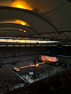 an overhead view of a large crowd at a concert with the lights on and people standing around