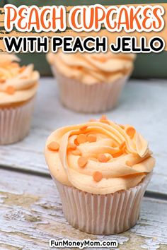 three cupcakes with peach jello frosting on top