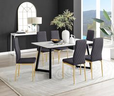 a dining room table with chairs and a potted plant