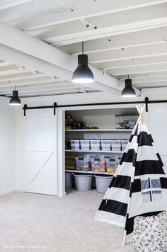 an old salt farm painted basement ceiling with black and white striped tent in the corner