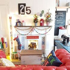 a living room filled with furniture and a fire place covered in christmas garlands on the mantle