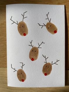 a card with four reindeer faces on it