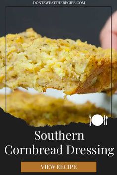 a person holding a piece of cornbread bread over a white plate with text that reads southern cornbread dressing view recipe