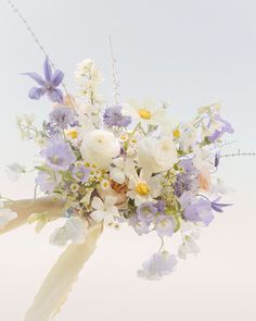 a bouquet of white and purple flowers