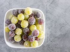 powdered sugar coated fruit in a white bowl