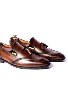 Burnt brown loafers in leather base with pipe pattern and round toe detailing.
Composition: Leather
Color: Brown
Other Details: 
Handcrafted
Round toe
Heel height (in inch): 0.75
 - Aza Fashions Luxury Brown Tassel Loafers For Business, Luxury Brown Tassel Loafers For Semi-formal, Luxury Brown Tassel Loafers For Semi-formal Occasions, Brown Leather Tassel Loafers With Plain Toe, Brown Slip-on Tassel Loafers With Leather Lining, Luxury Brown Tassel Loafers With Goodyear Welted, Brown Tassel Slip-on Loafers With Leather Lining, Brown Luxury Tassel Loafers For Formal Wear, Brown Luxury Tassel Loafers For Formal Occasions