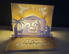 an illuminated christmas card with the birth of jesus and nativity scene in gold foil