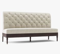 a white couch sitting on top of a wooden frame