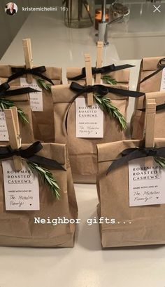 small brown bags with black ribbons tied around them and tags on the handles that say, neighbor gifts