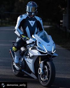 a man riding on the back of a white motorcycle