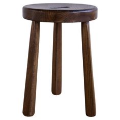 a wooden stool with two legs and a small seat on the bottom, made out of wood