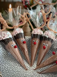 four chocolate cones decorated with candy and reindeer noses