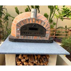 a brick oven with logs stacked on top