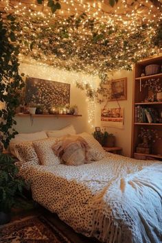 an unmade bed with lots of lights hanging from the ceiling and plants growing over it