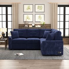 a living room with blue couches and windows