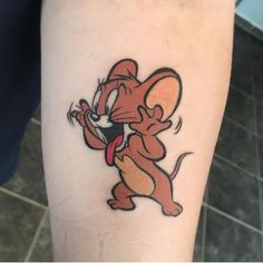 a cartoon mouse tattoo on the leg