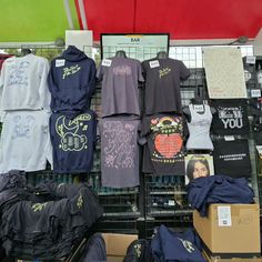 t - shirts and other items are on display in a store