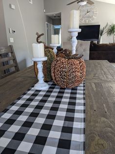 a dining room table with black and white checkered runner