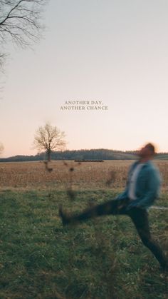 a man is running through the grass with his legs spread out