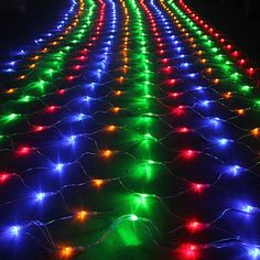 colorful lights are arranged in rows on the ground