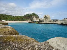 the water is blue and clear with rocks