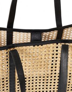 A rattan and leather tote in cool, neutral tones, Bembien's Margot bag is the go-anywhere, carry-everything bag for summer and beyond. Handwoven in Bali, it features a leather base that can handle the weight of all of your essentials and leather shoulder straps that feel soft as butter on sun-kissed shoulders. Its stylish, oversized shape is perfect for day trips, lazy beach days, and summer road trips. Luxury Woven Leather Rectangular Beach Bag, Luxury Black Straw Bag With Bamboo Handle, Luxury Black Top Handle Straw Bag, Luxury Black Casual Straw Bag, Luxury Rectangular Beach Bag For Shopping, Chic Leather Basket-shaped Bucket Bag, Chic Leather Basket Bucket Bag, Chic Leather Bucket Bag In Basket Shape, Chic Leather Bucket Bag With Basket Shape