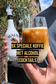 a person holding up a wine glass with alcohol in it that says 9x special koffie met alcohol cocktails