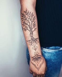 a person with a tree tattoo on their arm