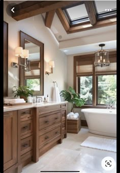 a bathroom with a large tub, sink and two windows in the middle of it