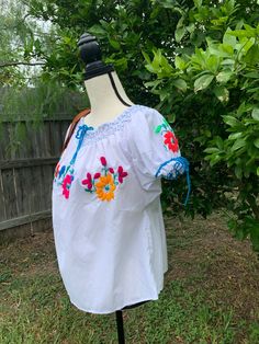 "Hand Embroidered Artisanal Blouse - Mexican Blouse - Fiesta Blouse - S/M This blouse had handcrafted details no other will have. It will fit a size small/medium Measurements: * 23\" long * 27\" wide Care * cloth wipe to clean * delicate care * hang dry Please email me your questions before buying. All of my items come from a smoke and pet free environment. I WILL BE PROCESS YOUR ORDER IN 1 DAY If you need the item expressed shipped please contact me to request it and the listing will be adjuste Artisan Embroidered Tops For Summer, Artisan Embroidered Summer Top, Traditional Spring Blouse With Machine Embroidery, Cotton Peasant Blouse With Embroidered Neckline, Multicolor Floral Embroidered Peasant Top, Multicolor Folk Peasant Top With Short Sleeves, Multicolor Short Sleeve Folk Peasant Top, Multicolor Folk Style Short Sleeve Peasant Top, Multicolor Floral Embroidery Peasant Top