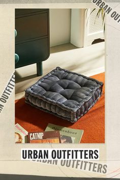 an advertisement for urban outfitters featuring a square cushion on the floor in front of a dresser