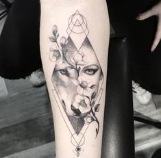 a woman's face with flowers and geometric shapes on her leg, in black and white