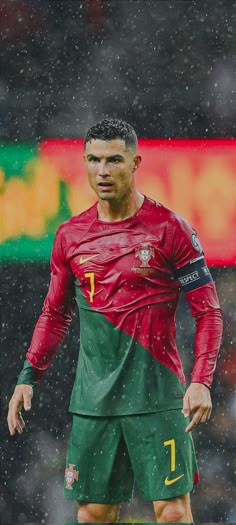 the soccer player is standing in the rain